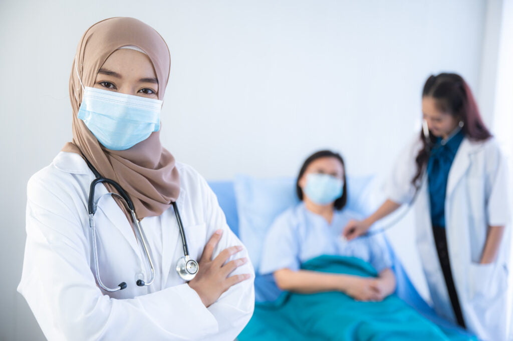A doctor performing a pre-employment check-up on a patient